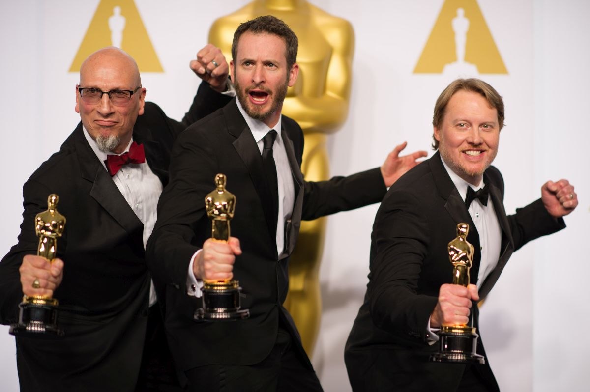 Chris Williams (center) with Roy Conli (left) and Don Hall (right) after winning the Oscar for Best Animated Feature for Big Hero 6