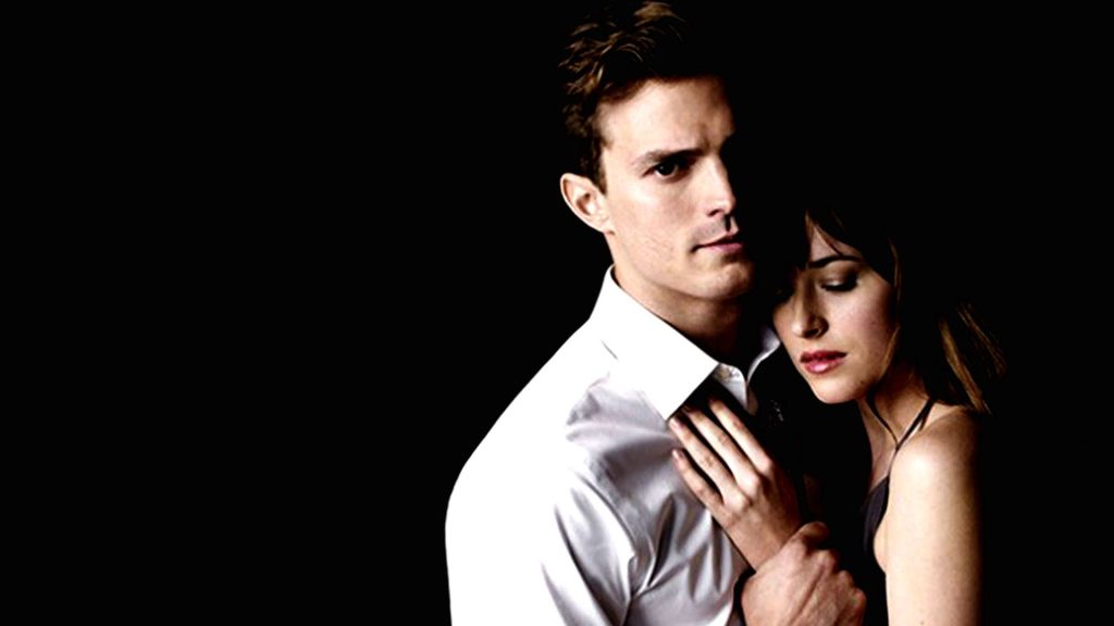 Jamie Dornan (left) and Dakota Johnson (right) in Fifty Shades of Grey.