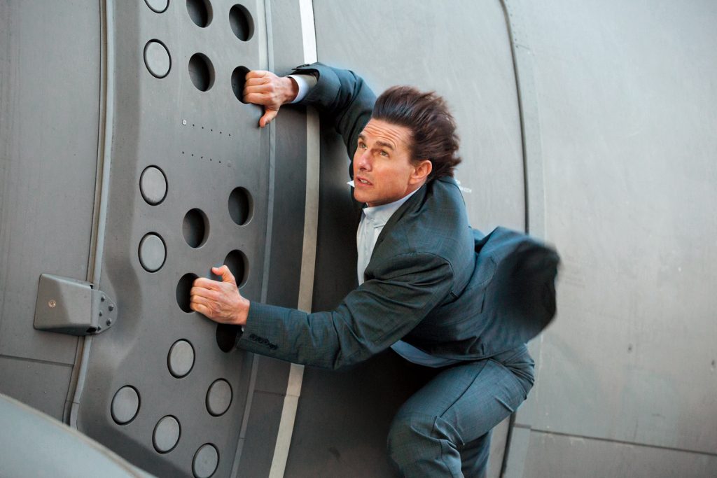 Tom Cruise as Ethan Hunt hanging out of an airplane (Mission Impossible: Rouge Nation).